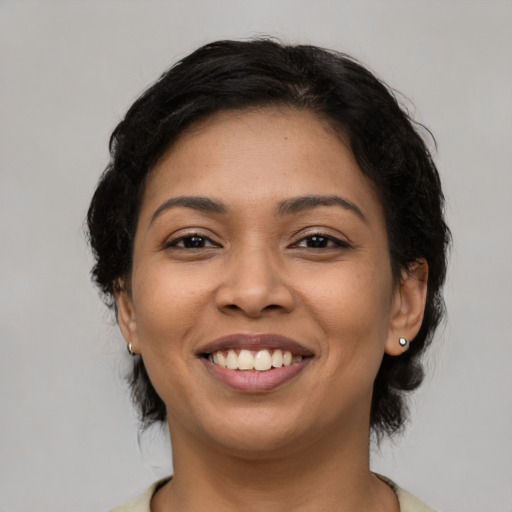 Joyful latino young-adult female with medium  brown hair and brown eyes