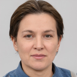 Joyful white adult female with short  brown hair and grey eyes