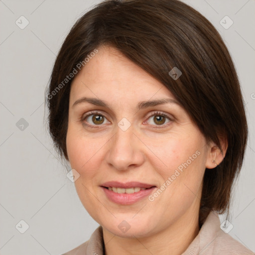 Joyful white adult female with medium  brown hair and green eyes