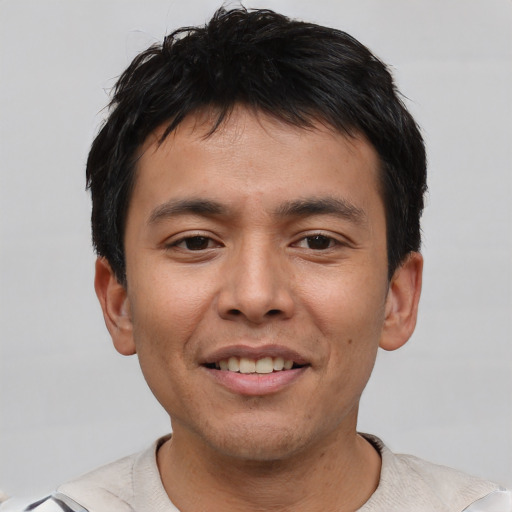 Joyful asian young-adult male with short  black hair and brown eyes