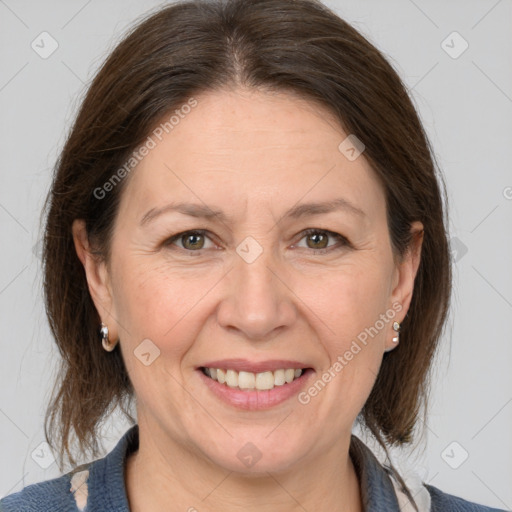 Joyful white adult female with medium  brown hair and grey eyes