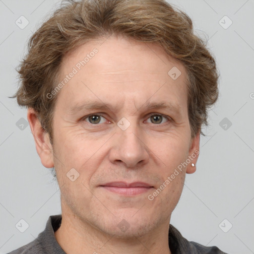 Joyful white adult male with short  brown hair and grey eyes