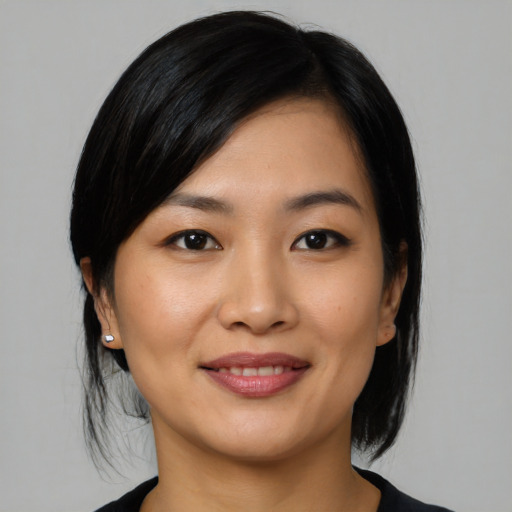 Joyful asian young-adult female with medium  black hair and brown eyes