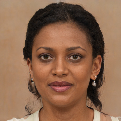 Joyful black young-adult female with medium  brown hair and brown eyes