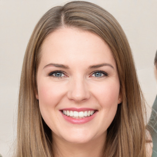 Joyful white young-adult female with long  brown hair and brown eyes