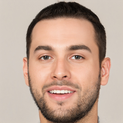 Joyful white young-adult male with short  black hair and brown eyes