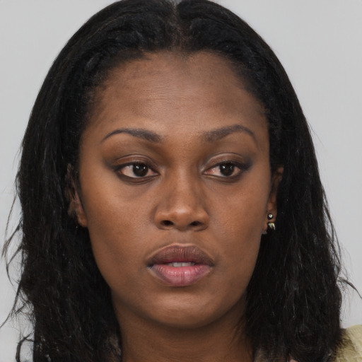 Neutral black young-adult female with long  brown hair and brown eyes