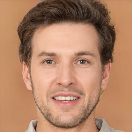 Joyful white adult male with short  brown hair and brown eyes