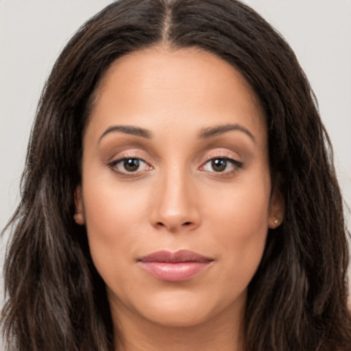 Joyful latino young-adult female with long  brown hair and brown eyes