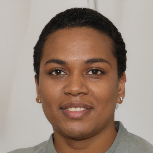 Joyful black young-adult female with short  black hair and brown eyes