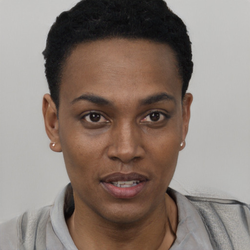 Joyful black young-adult female with short  black hair and brown eyes