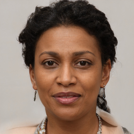 Joyful black adult female with short  brown hair and brown eyes