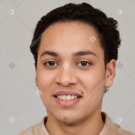 Joyful latino young-adult male with short  brown hair and brown eyes