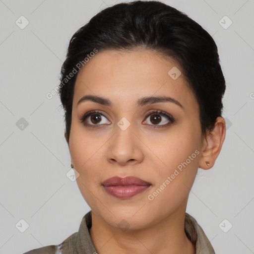 Joyful latino young-adult female with short  brown hair and brown eyes