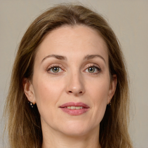 Joyful white young-adult female with long  brown hair and green eyes