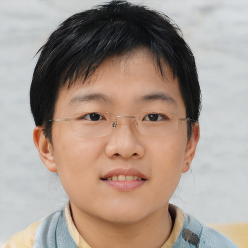 Joyful asian child male with short  brown hair and brown eyes