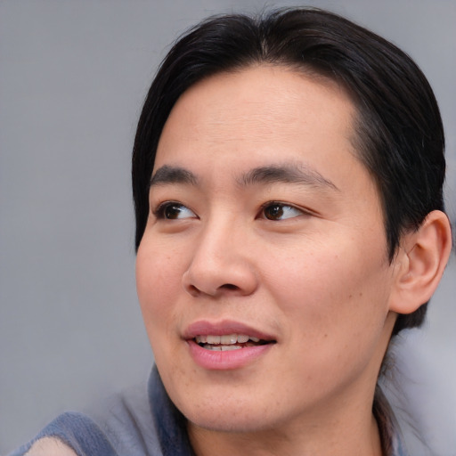Joyful asian young-adult male with medium  brown hair and brown eyes