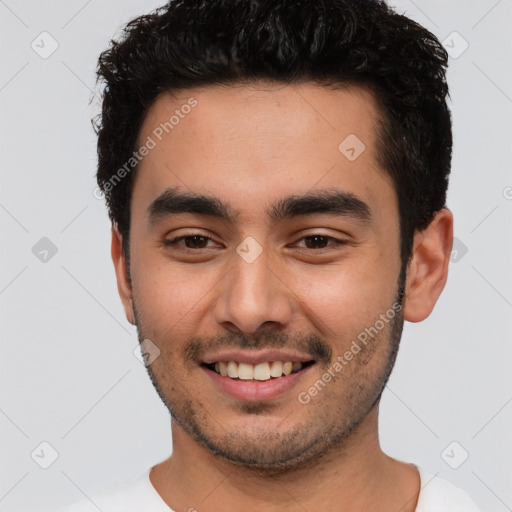 Joyful white young-adult male with short  black hair and brown eyes