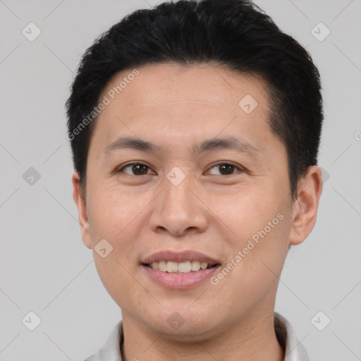 Joyful white young-adult male with short  black hair and brown eyes