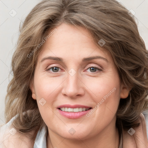 Joyful white adult female with medium  brown hair and blue eyes