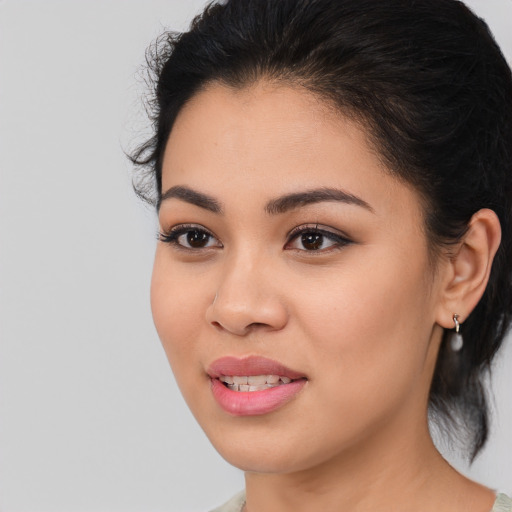 Joyful latino young-adult female with medium  brown hair and brown eyes