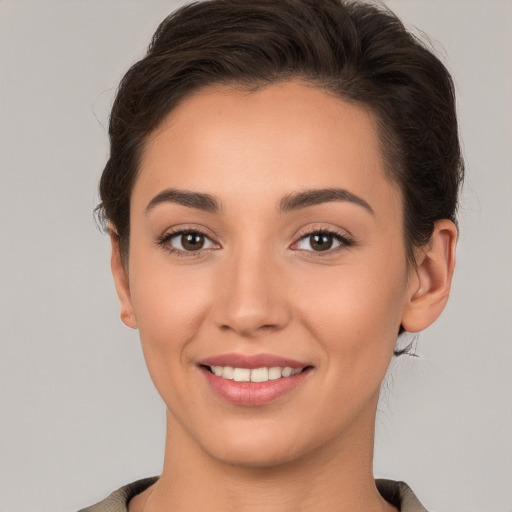 Joyful white young-adult female with short  brown hair and brown eyes