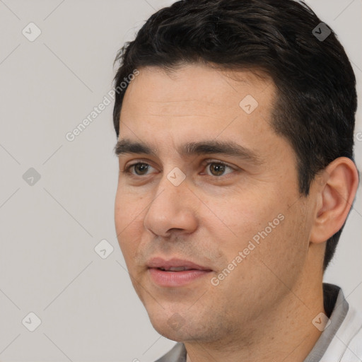 Joyful white young-adult male with short  black hair and brown eyes