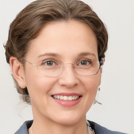 Joyful white adult female with medium  brown hair and blue eyes