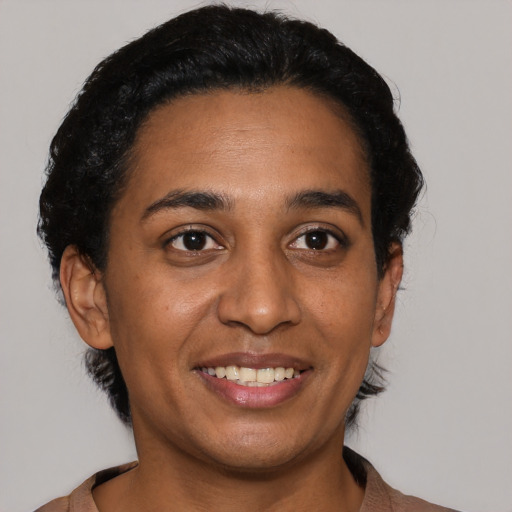 Joyful latino young-adult female with short  black hair and brown eyes