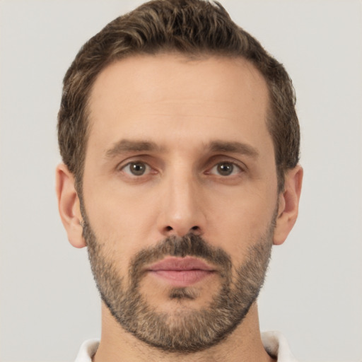 Joyful white adult male with short  brown hair and brown eyes