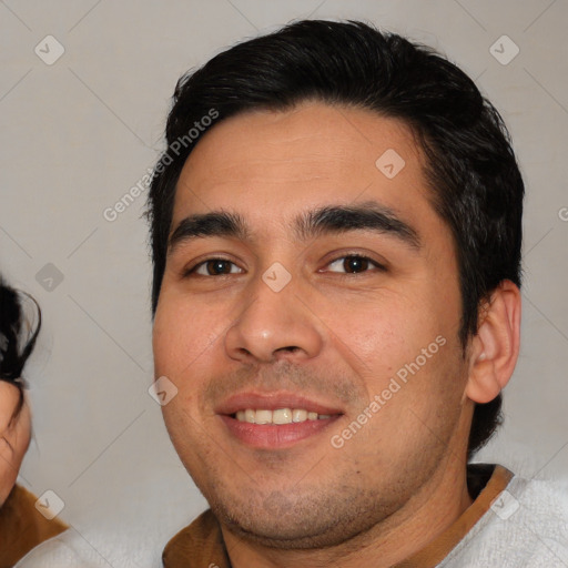 Joyful white young-adult male with short  black hair and brown eyes