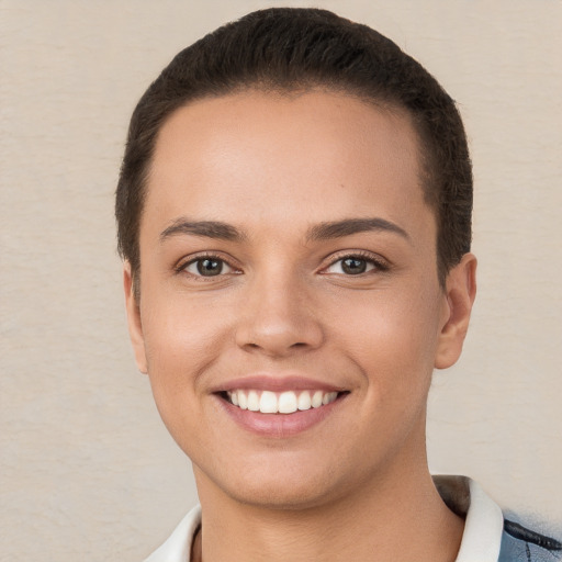 Joyful white young-adult female with short  brown hair and brown eyes