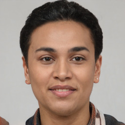 Joyful latino young-adult male with short  black hair and brown eyes