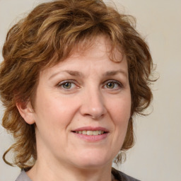 Joyful white adult female with medium  brown hair and grey eyes