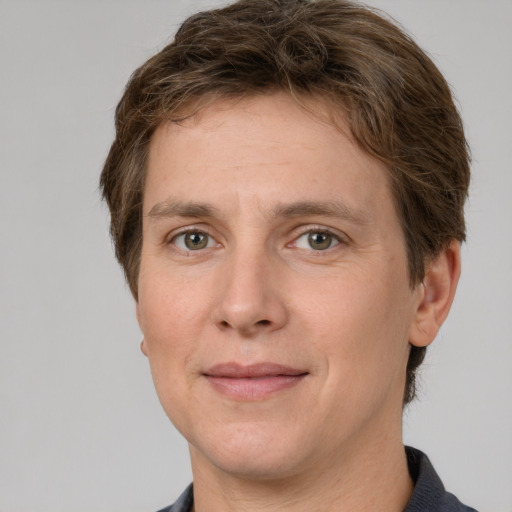 Joyful white adult male with short  brown hair and grey eyes