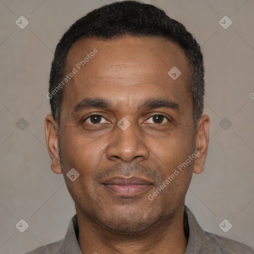 Joyful latino adult male with short  black hair and brown eyes