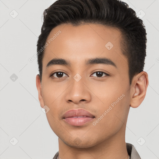 Joyful latino young-adult male with short  black hair and brown eyes