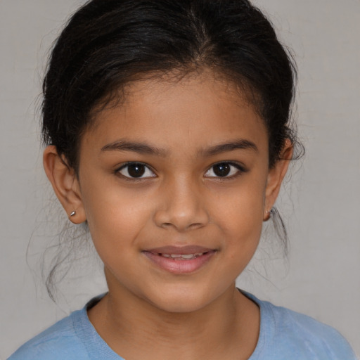 Joyful latino child female with medium  brown hair and brown eyes