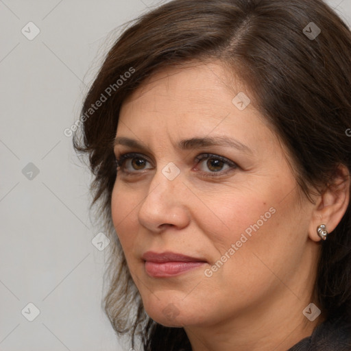 Joyful white adult female with medium  brown hair and brown eyes