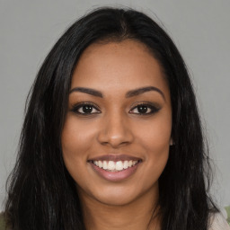 Joyful latino young-adult female with long  brown hair and brown eyes