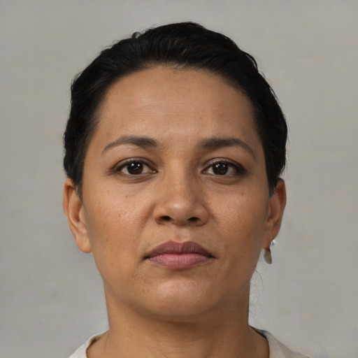 Neutral latino adult female with short  black hair and brown eyes