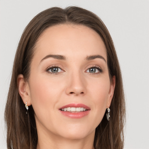 Joyful white young-adult female with long  brown hair and grey eyes