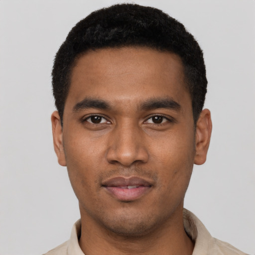Joyful black young-adult male with short  black hair and brown eyes