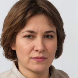 Joyful white adult female with medium  brown hair and grey eyes