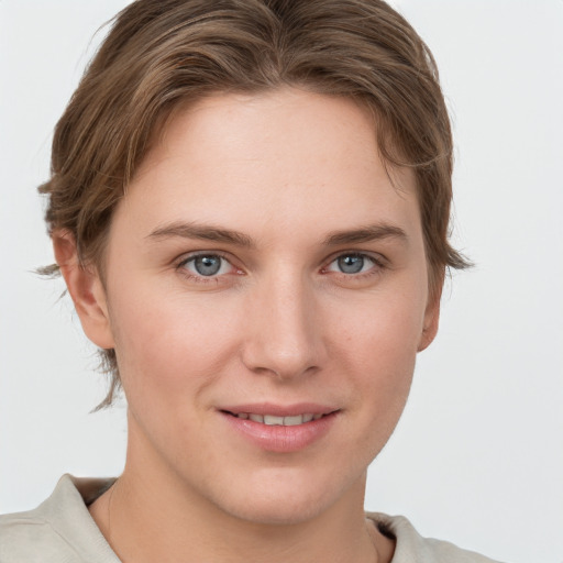 Joyful white young-adult female with short  brown hair and grey eyes