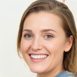 Joyful white young-adult female with medium  brown hair and blue eyes