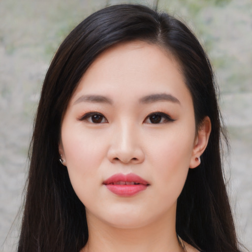 Joyful asian young-adult female with long  brown hair and brown eyes