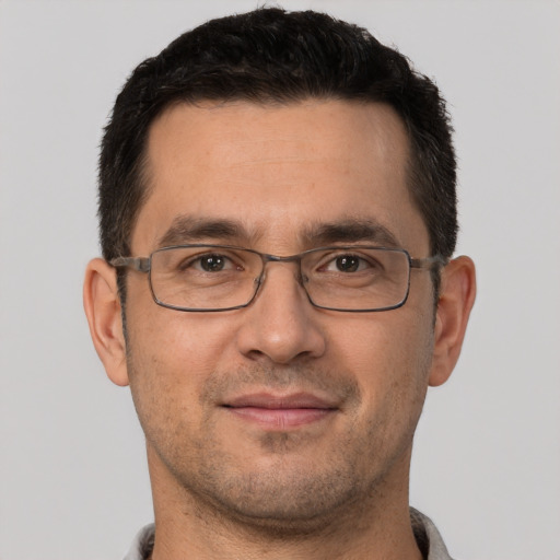 Joyful white adult male with short  brown hair and brown eyes