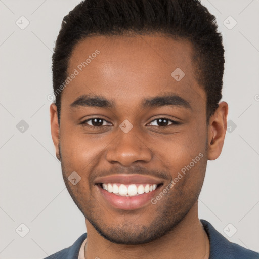 Joyful black young-adult male with short  brown hair and brown eyes