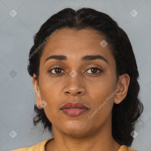 Joyful latino adult female with short  brown hair and brown eyes